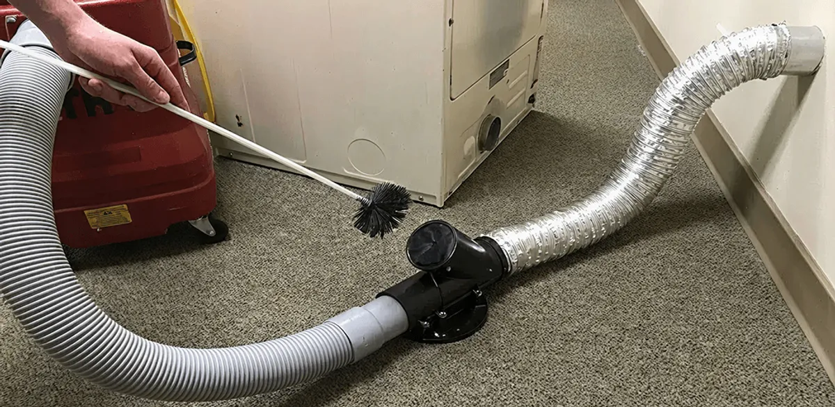Dryer vent cleaning service removing lint from a dryer duct connection in Henderson, NV